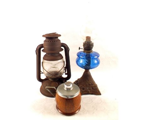 An oil lamp, storm lantern and a tea caddy