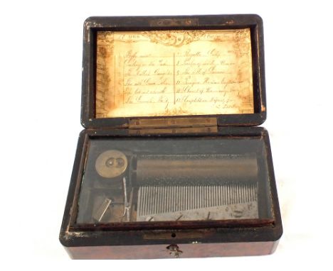 A Amboyna music box playing twelve airs, 6" x 3 1/2"