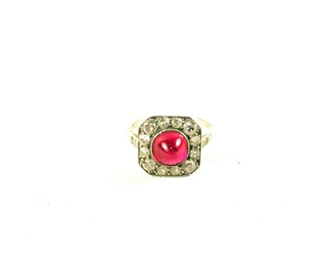 A Ruby and Diamond Art Deco style ring, central Ruby with Diamond border in square shape with Diamond set shoulders, believed