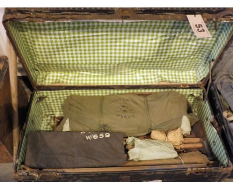 A vintage trunk with contents, including a tent, camp bed and a WWII dated kit bag