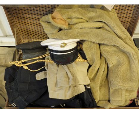 A vintage travelling trunk containing a large quantity of vintage clothing, including military examples