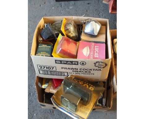 Four boxes of vehicle spares etc including light fittings and belts