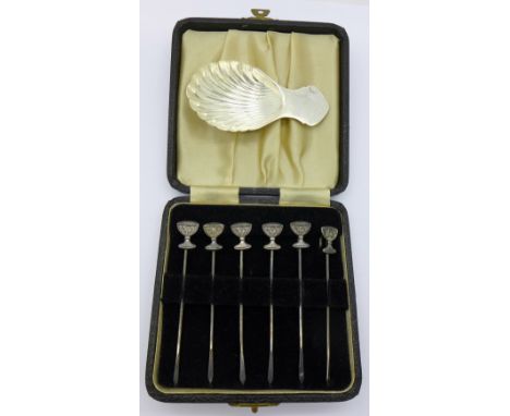 A silver caddy spoon and a cased set of six hallmarked silver cocktail sticks