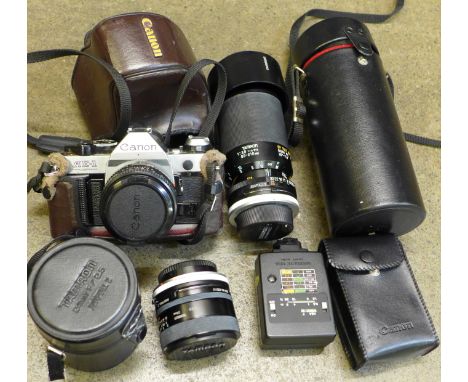 A Canon AE-1 Program camera with lens, two additional Tamron lenses, 80-210mm f/3.8-4 and 24mm f/2.5 and a Speedlight 133A fl