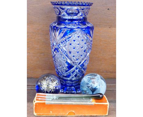 A Caithness glass paperweight, one other paperweight, a glass pickle fork, possibly 19th Century and a Bohemian blue flash cu