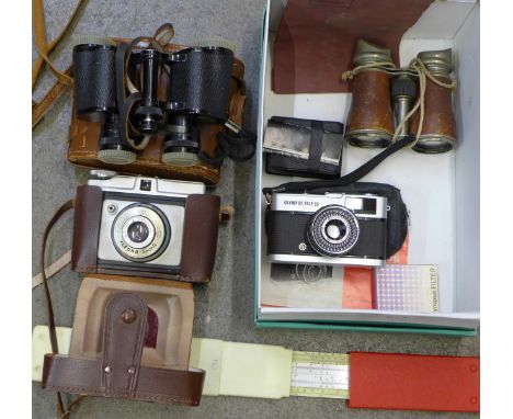 A pair of Boots 8x30 binoculars, a pair of field glasses, an Aristo Scholar slide rule, Olympus Trip 35 and Ilford cameras an