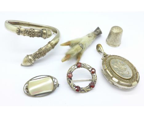 A Victorian locket, a silver thimble, three brooches and a bangle, bangle a/f