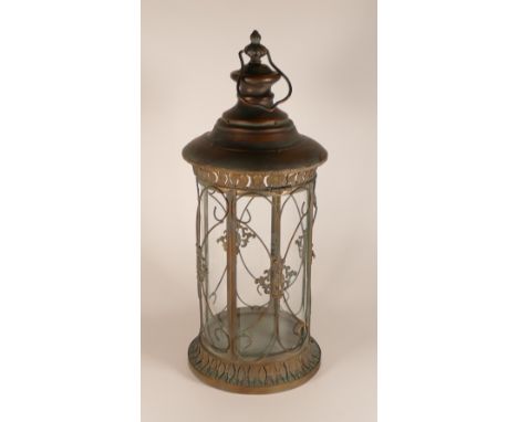 Ornate metal and glass round lantern, with hinged door and carrying handle, h.57 x d.25cm.