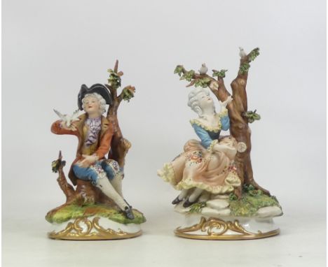 Capodimonte, Pair of porcelain figures in 18th century dress in naturalistic bases. Height: 23cm (2)