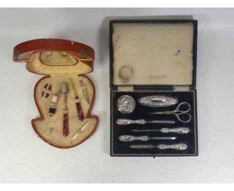 Two Cased Vanity Sets, includes on Hallmarked Silver Complete Set in Black Case together with partially complete in red case.