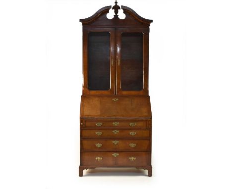 A late George II and later walnut veneered bureau bookcase, crossbanded and feather-banded, the later upper section with a br