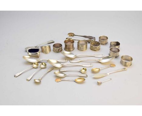 A collection of nine silver napkin rings, together with a silver salt with blue glass liner, four silver salt spoons, a silve