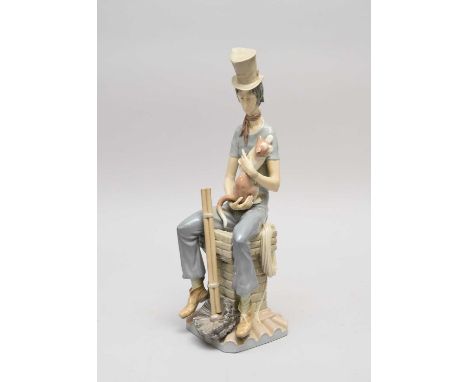 A Lladro porcelain model of a sad chimney sweep with a cat, designed by Salvador Furió in 1974 and retired in 1983, 44cm high