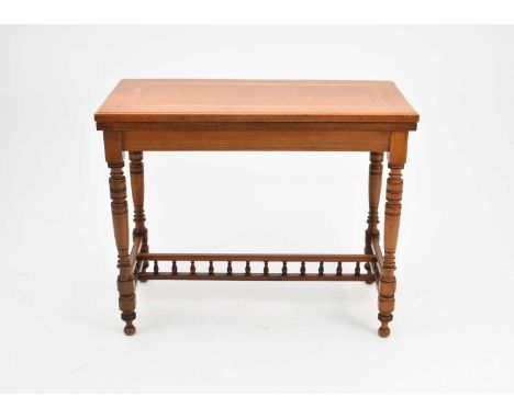 An Edwardian walnut and satinwood inlaid card table, the revolving top inlaid with ebony and boxwood stringing around satinwo