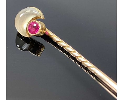 UNMARKED GOLD STICKPIN set with a crescent shaped moonstone and a ruby, 6cms (l), 2.2gms, in fitted caseProvenance: deceased 
