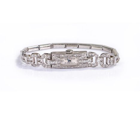 Platinum and diamond set ladies wristwatch, the white enamel dial with Roman hours, diamond set rectangular case, manual woun