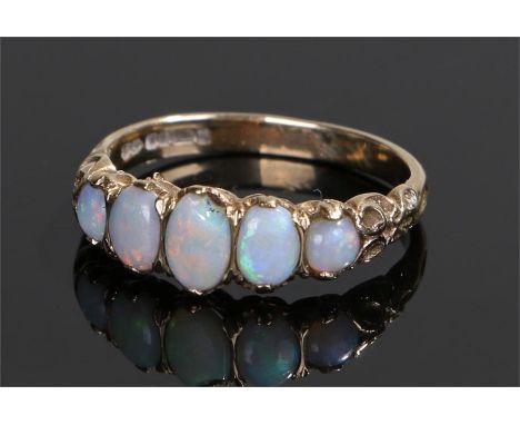 9 carat gold opal set ring, with a row of five oval opals, ring size N