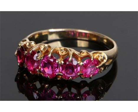 18 carat gold ruby set ring, with a row of five rubies, ring size Q