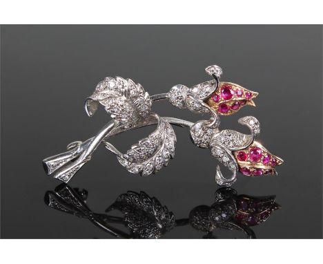 Diamond and ruby brooch, the yellow metal flower heads set with rubies above the white metal body with all over round cut dia