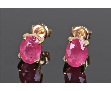 Pair of 18 carat gold ruby earrings, each with a ruby at approximately 8mm high on 18 carat gold