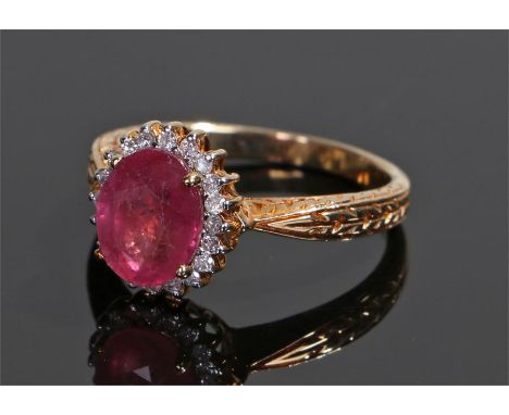 9 carat gold ruby and diamond ring, the central ruby at 2 carats with diamond surround, ring size O