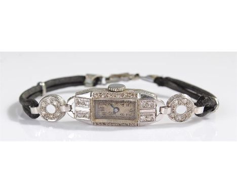 Platinum and diamond ladies wristwatch, the silvered dial with Arabic hours, diamond set rectangular case, manual wound, case