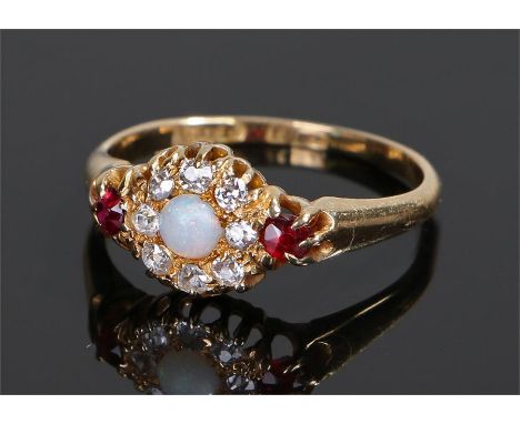 18 carat gold opal diamond and ruby ring, the central opal with diamond surround and a pair of rubies to the shoulders, ring 