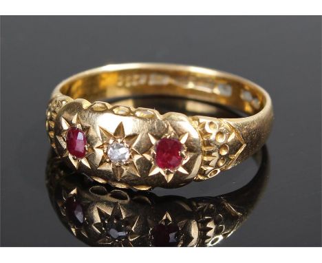 18 carat ruby and diamond set ring, the central diamond flanked by a pair of diamonds, ring size Q