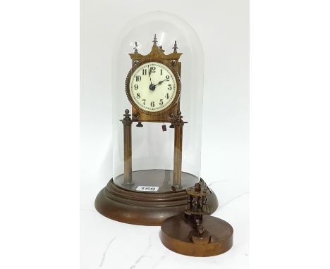 A brass anniversary clock with a glass dome, enamel dial, height 29cm.