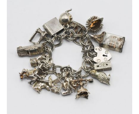 A mainly silver charm bracelet, to include a hedgehog charm, a ship in bottle, a witch, etc.