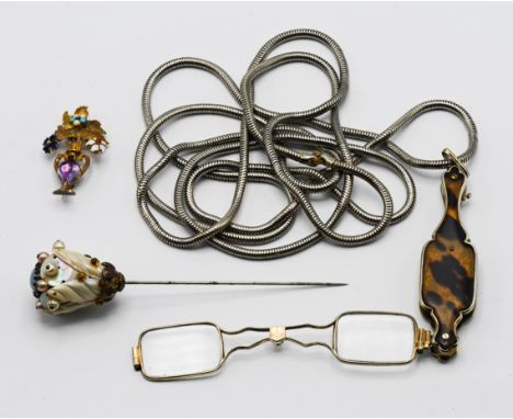 A large Victorian cravat pin in the form of a flower, with a pair of folding lunettes on a long chain, and a Victorian yellow