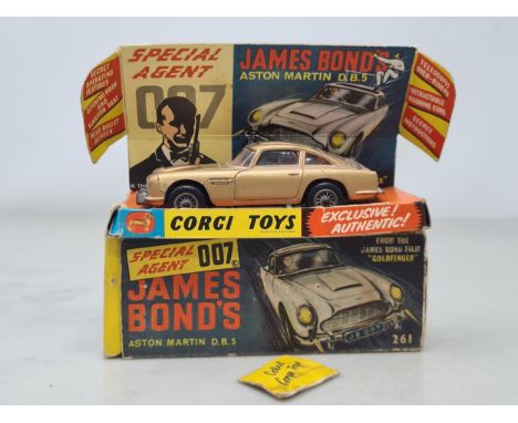A boxed Corgi Toys No.261 James Bond 007 Aston Martin D.B.5, G, box G (missing end flap), complete with insert and secret doc