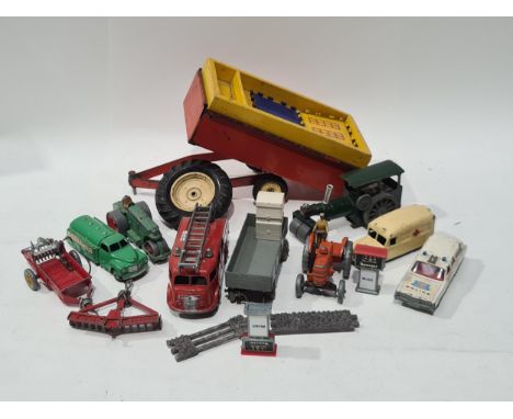 A box containing an unboxed Dinky Toys Castrol Tanker, Daimler Ambulance, Roller, Field Major Tractor, Muck Spreader, Fire En