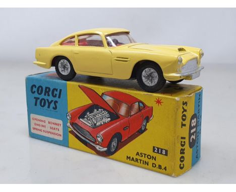 A boxed Corgi Toys No.218 yellow Aston Martin D.B.4 with cast hubs, M, box Ex plus