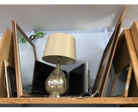 Two TVs, various pictures and mirrors and a lamp