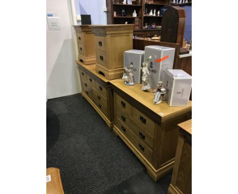 Two light oak chest of drawers and a pair of bedside chests