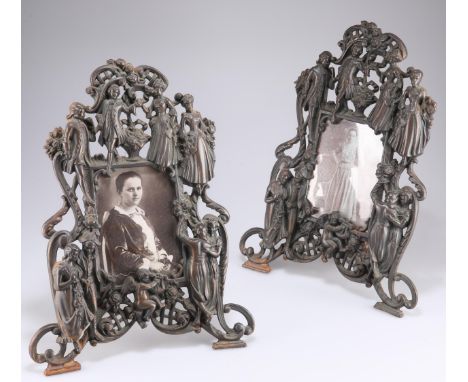 A PAIR OF ORNATE VICTORIAN COPPER EASEL PHOTOGRAPH FRAMES, cast and pierced, the rectangular apertures within heavily cast fr