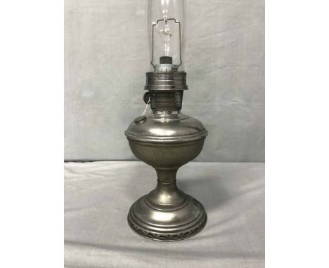 FOUR PARAFFIN LAMPSincluding a chrome Aladdin paraffin lamp, an Edwardian example and two brass centre draft lamps 