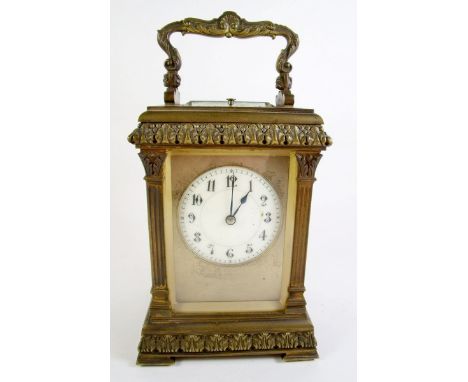 A 19th century brass cased carriage clock by Henri Jacot, Paris with pillastas flanking enamel dial and with stiff leaf borde