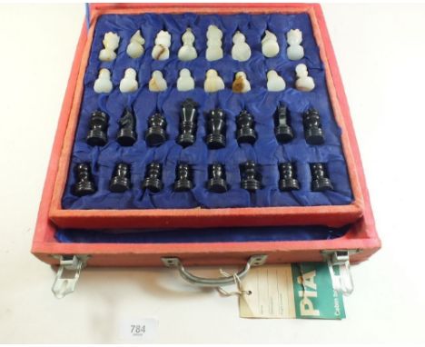 An alabaster chess set in original red cloth carrying case