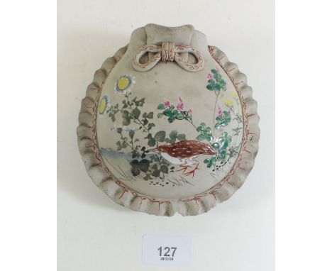 A Japanese ceramic wall pocket with enamelled decoration of a bird in foliage - 13cm tall