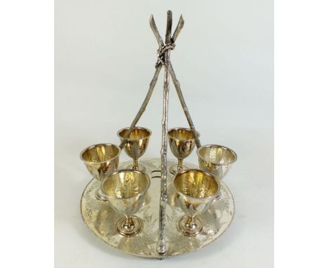 A Victorian silver egg cup stand and six egg cups by Fenton Brothers Sheffield 1874, with triple rustic stick form handle and