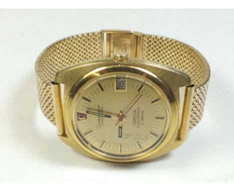 A gold plated 1970's Omega Constellation chronometer wrist watch Electronic F300 Hz, with 9 carat gold strap and box and pape