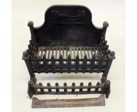 A cast iron fire grate with ploughing scene to back 56cm wide approximately