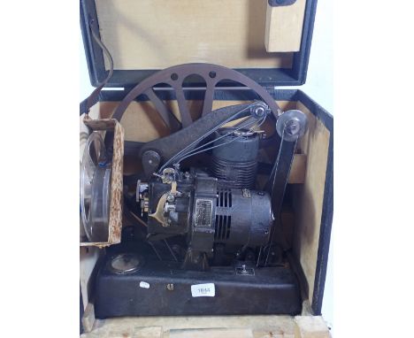 A Bell and Howell Cine 129 vintage projector, a Celfix Cine screen and various empty reels