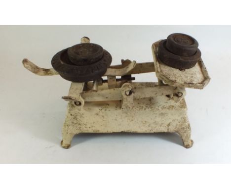 A set of cast iron kitchen scales with eight weights