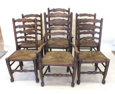 A set of six ladder back dining chairs with rush seats - four diners and two carvers