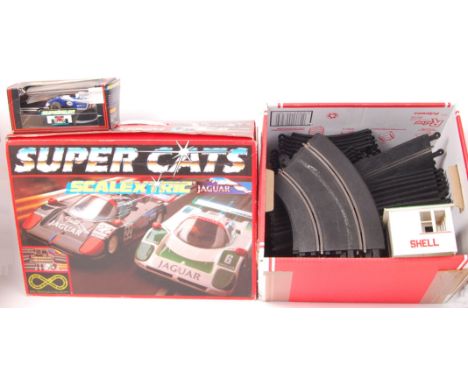 An original 'Super Cats' Jaguar Scalextric set within its original box (appears complete) also, to include a box of curved tr