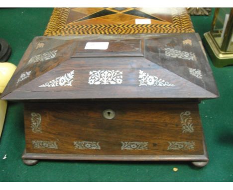 A sarcophagus-shaped rosewood tea caddy with mother-of-pearl inlay