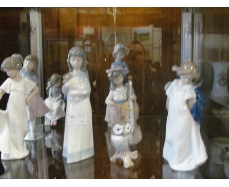 Nine various Nao figurines; together with one Lladro figurine and a Lladro-style figurine